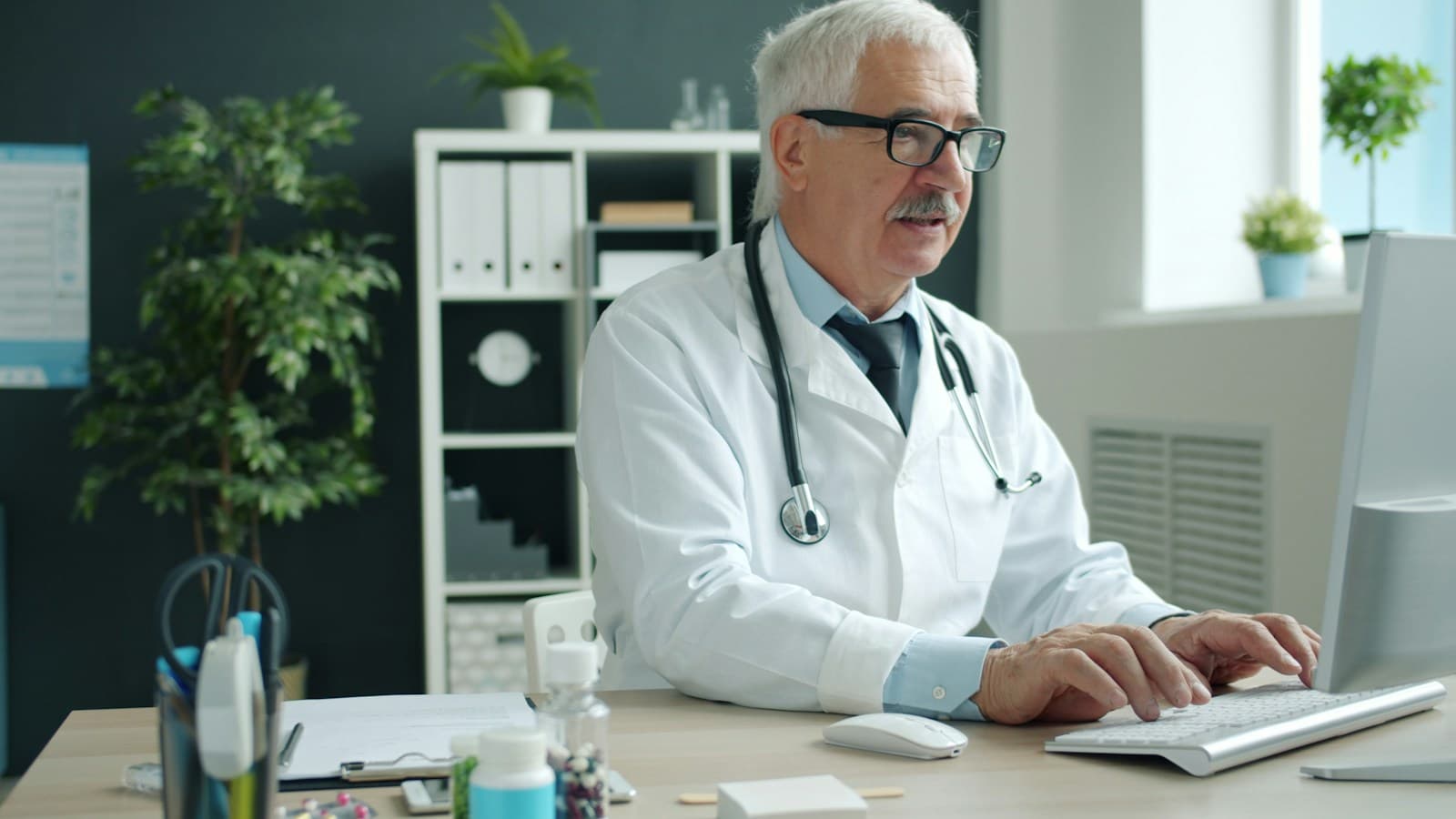 A doctor working at a computer